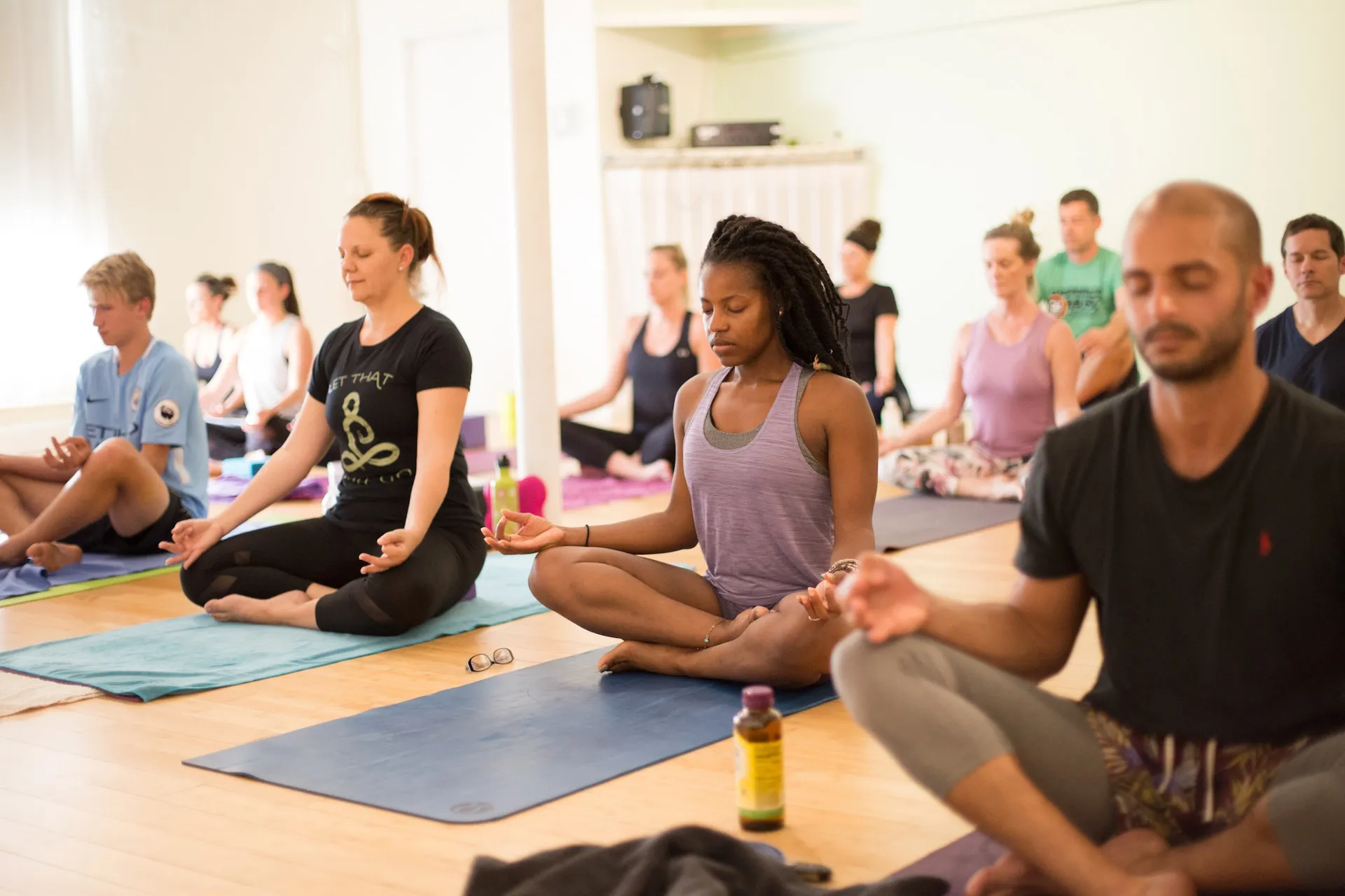 A photo of some people breathing in a yoga class at my studio